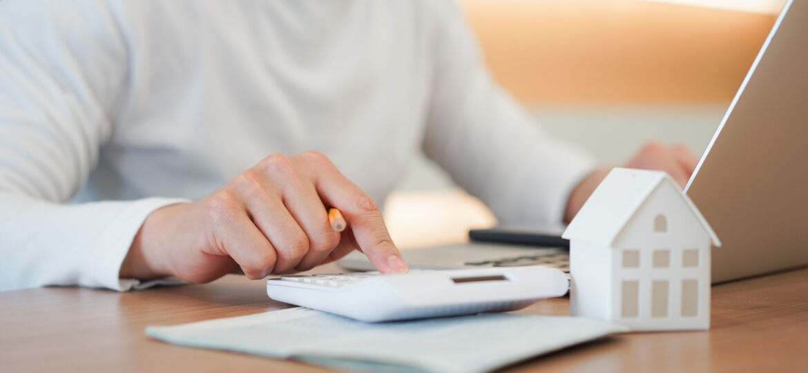 Close,Up,Young,Man,Hand,Press,On,Calculator,To,Check